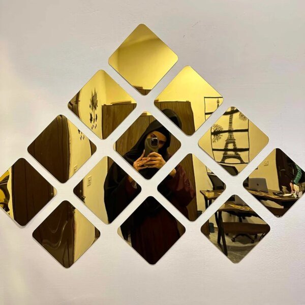 Acrylic mirrors hang on the wall, reflecting the frames of other mirrors.