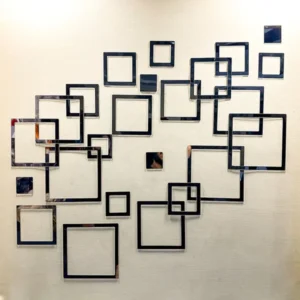 Acrylic mirrors hang on the wall, reflecting the frames of other mirrors. Polka Square Rings Mirror Acrylic Wall Decor