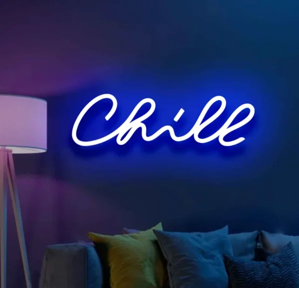 a neon light on the wall displays the text chill