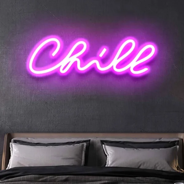 a neon light on the wall displays the text chill. Neon Light Chill Sign