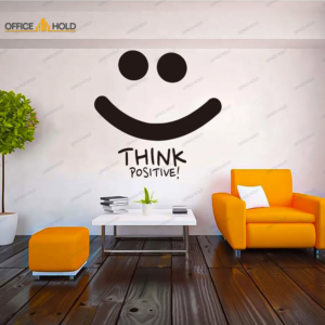 a table and a orange color couch near the wall and text written on the wall for wall decoration. Think Positive Motivational Art