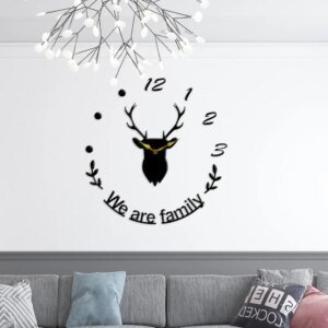 a black color clock and text written on the wall for wall decoration