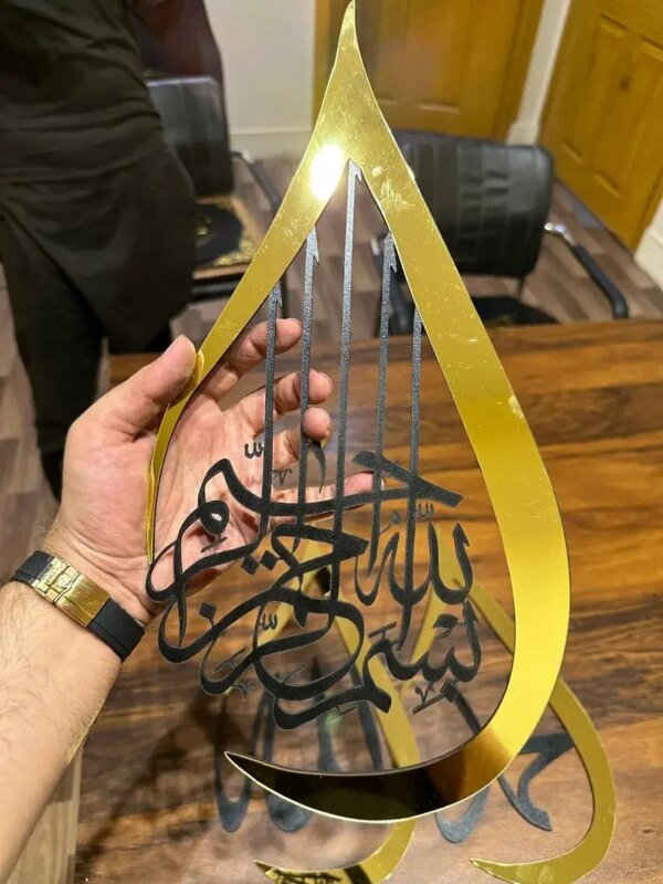 a hand holding golden color frame