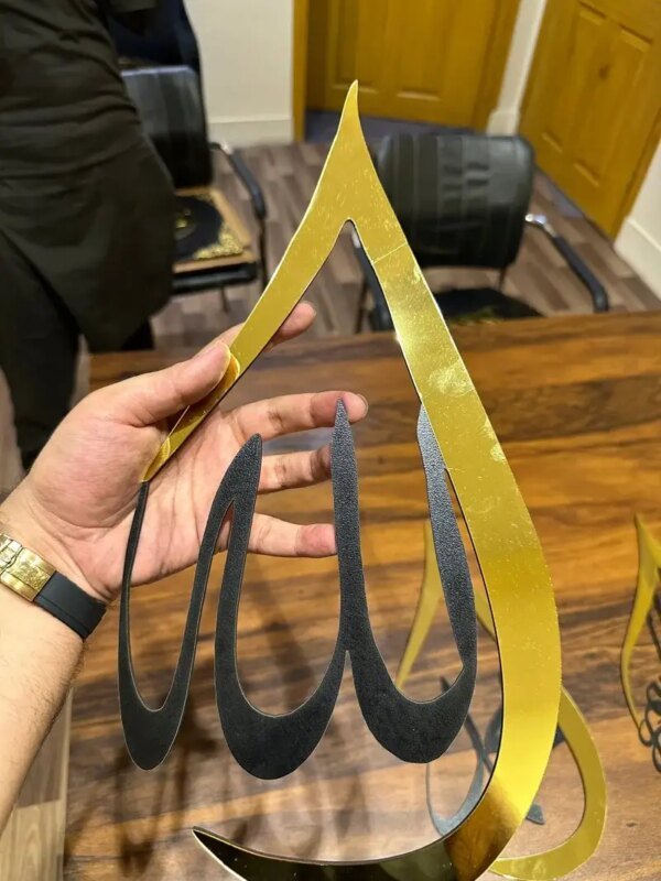 a hand holding golden color frame