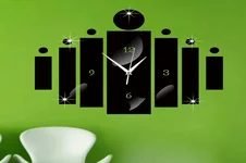 a black color clock on the green wall